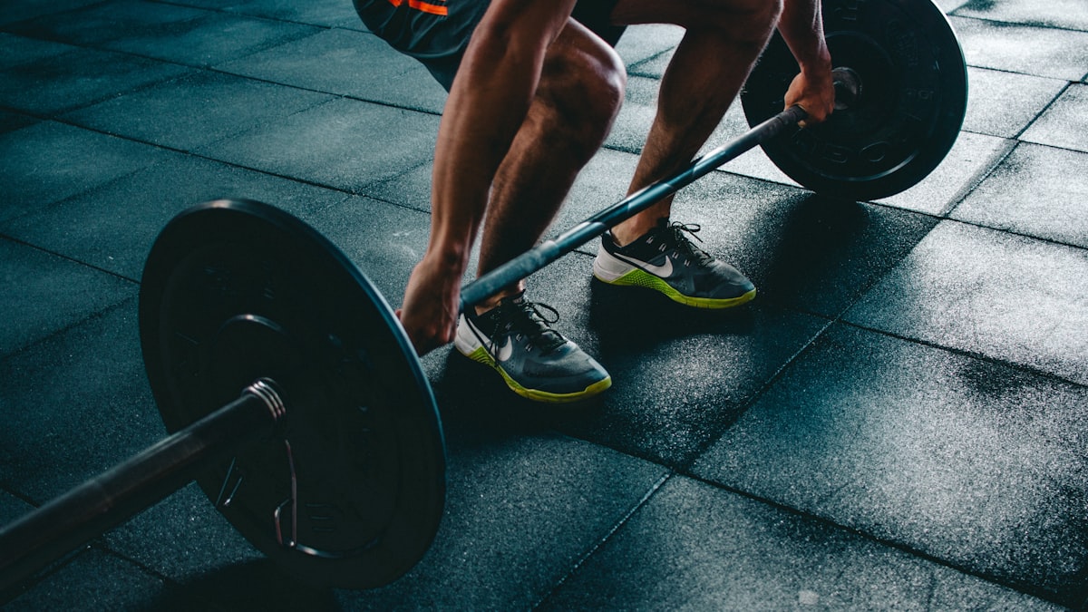 Person lifting a barbell during a gym workout